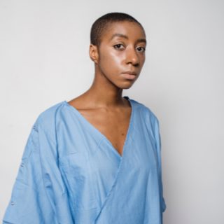 woman looking sad in blue hospital dress