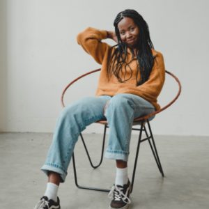 black girl sitting down and smiling