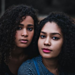 two women with curly hair