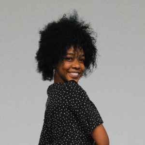 black woman with afro smiling
