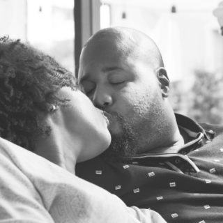 black man and woman kissing