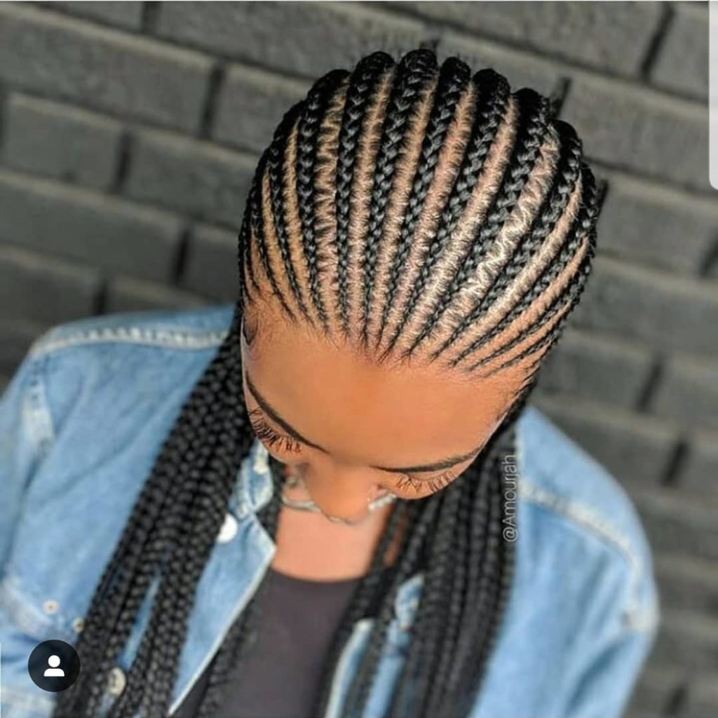 black lady showing her freshly made cornrows