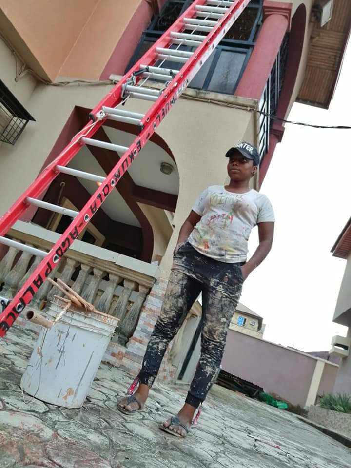 Photo of Mimi Faith, female painter, with her ladder and paint bucket