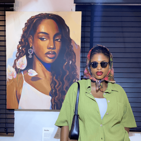 Renike the fine artist posing with her artwork