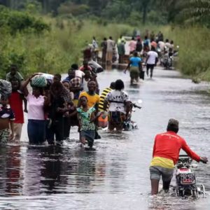 Image of Nigerians walking in a flooded community