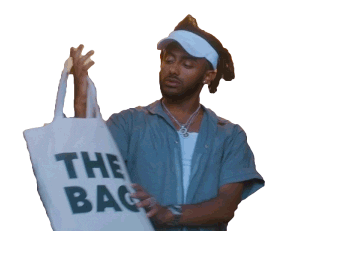 amine carrying a tote bag with a bold inscription reading "THE BAG"