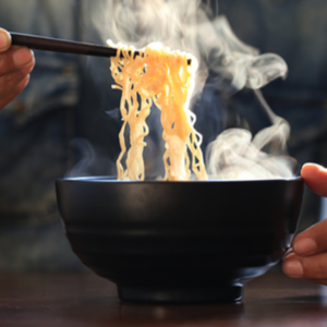 Image of person eating noodles